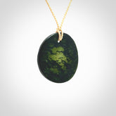 Hand carved New Zealand Jade disc pendant with adjustable beige cord. Unique hand made art to wear.